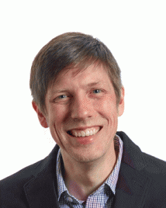 short haired, blue eyes man with black blazer.