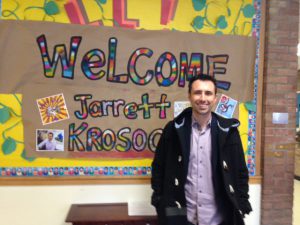 Author in front of welcome sign.