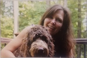 LES social worker Catherine Ricchetti hugs her service dog, Copeland
