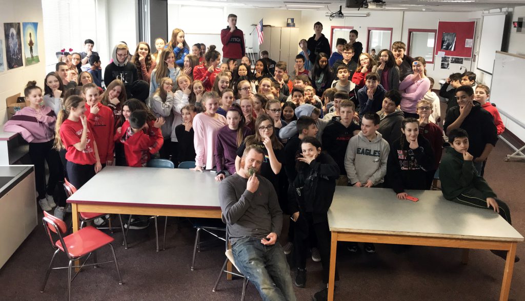 Big group photo of FMS students posing with Mr. Duesler