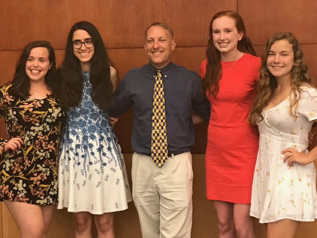 Four GHS seniors awarded scholarships, pose with principal