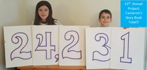 Project Cameron's Story book number reveal. His brother and sister hold a sign indicating 24,231 books were donated in 2020.