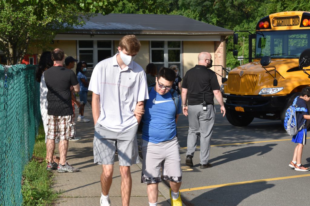 student and teacher walking together