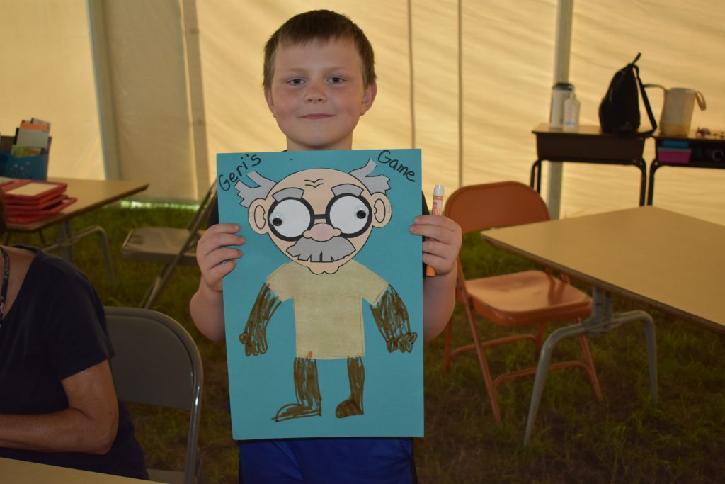 student holding a drawing