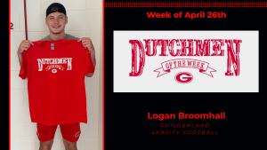 Student athlete Logan Broomhall smiles for the camera holding a red Dutchmen shirt with white lettering.