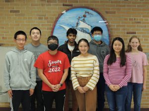 Eight seniors posing for the camera after being chosen as National Merit Scholarship semifinalists.