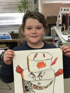 GES student named young artist of the month holding her artwork.