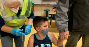 Student being prepped for vaccine.