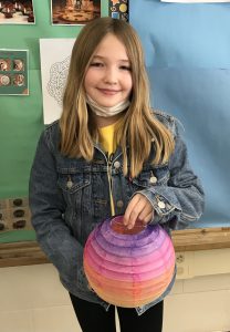 GES student holding artwork