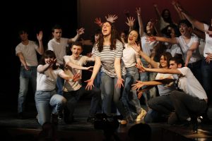 Students singing and dancing as part of a performance of Smokey Joe's Cafe