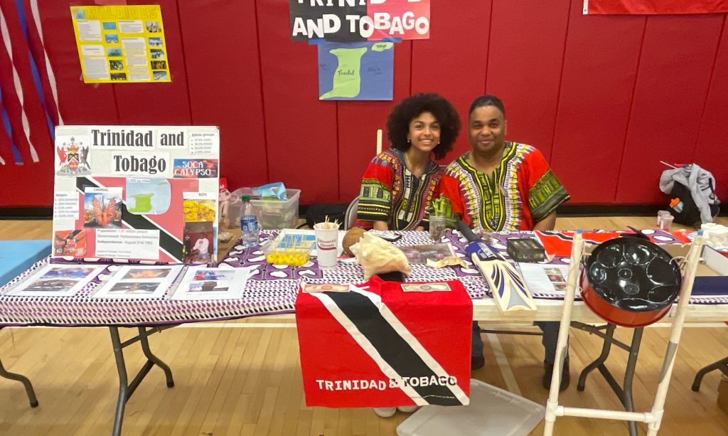 GHS student with her father and their booth on "Trinidad & Tobogao"