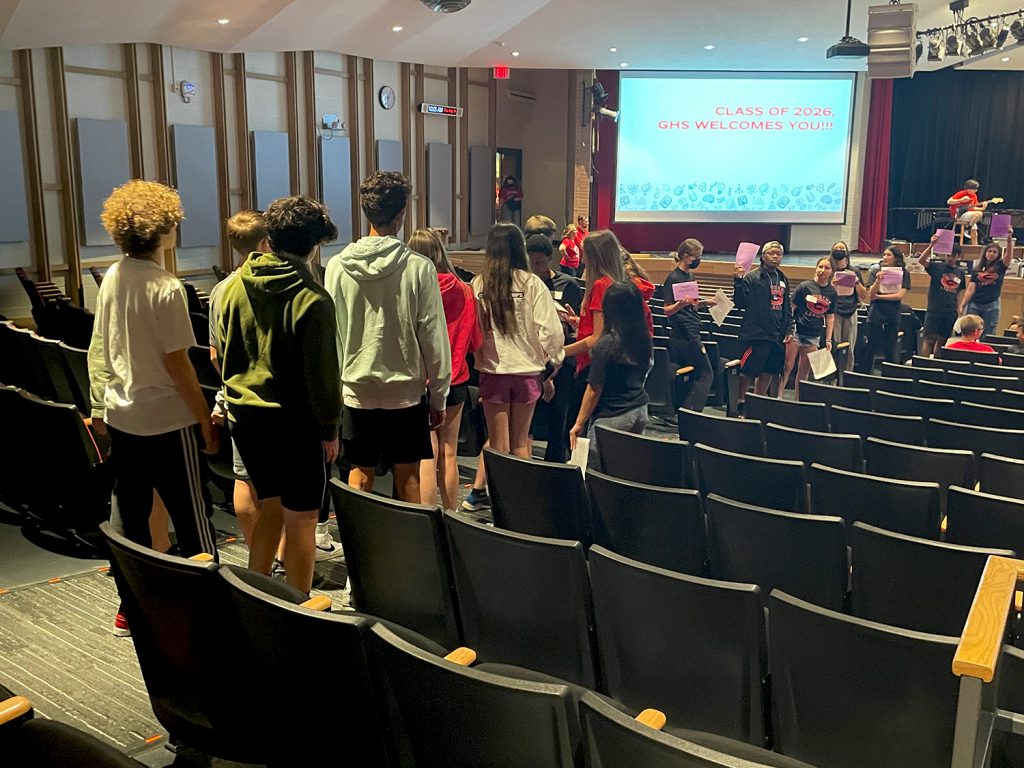 FMS students are gathering in the GHS Auditorium. GHS student leaders are guiding them to their seats.