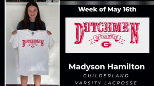 Student holding t-shirt who earned Dutchmen of the Week honors