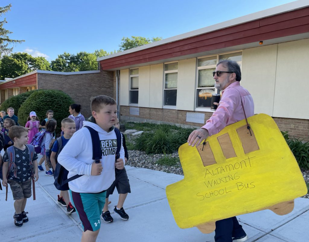 AES principal and student at front of school