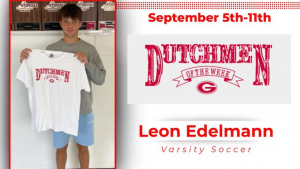 Varsity soccer player holding Dutchmen of the Week t-shirt