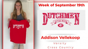Student holding red t-shirt that says "Dutchmen of the Week"