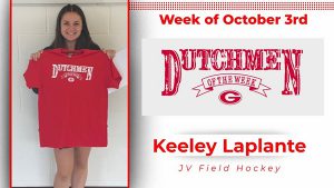 Student holding red t-shirt that says "Dutchmen of the Week"