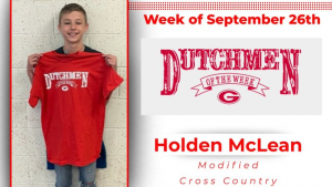 Student holding red t-shirt that says "Dutchmen of the Week"