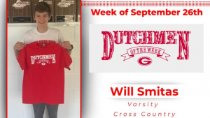 Student holding red t-shirt that says "Dutchmen of the Week"