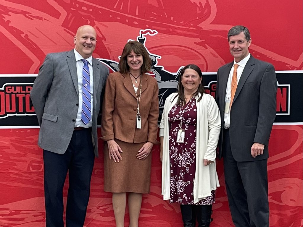 Four district administrators/leaders smiling for a photo.