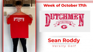 Student holding red t-shirt that says "Dutchmen of the Week"