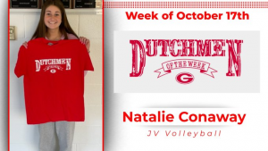 Student holding red t-shirt that says "Dutchmen of the Week"