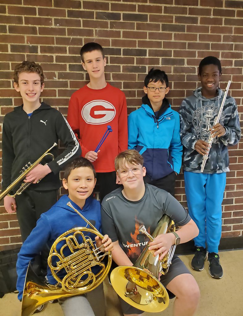 Six students holding their instruments for a group photo.