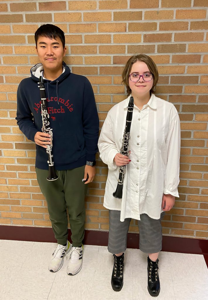 Two students holding their instruments for a photo.