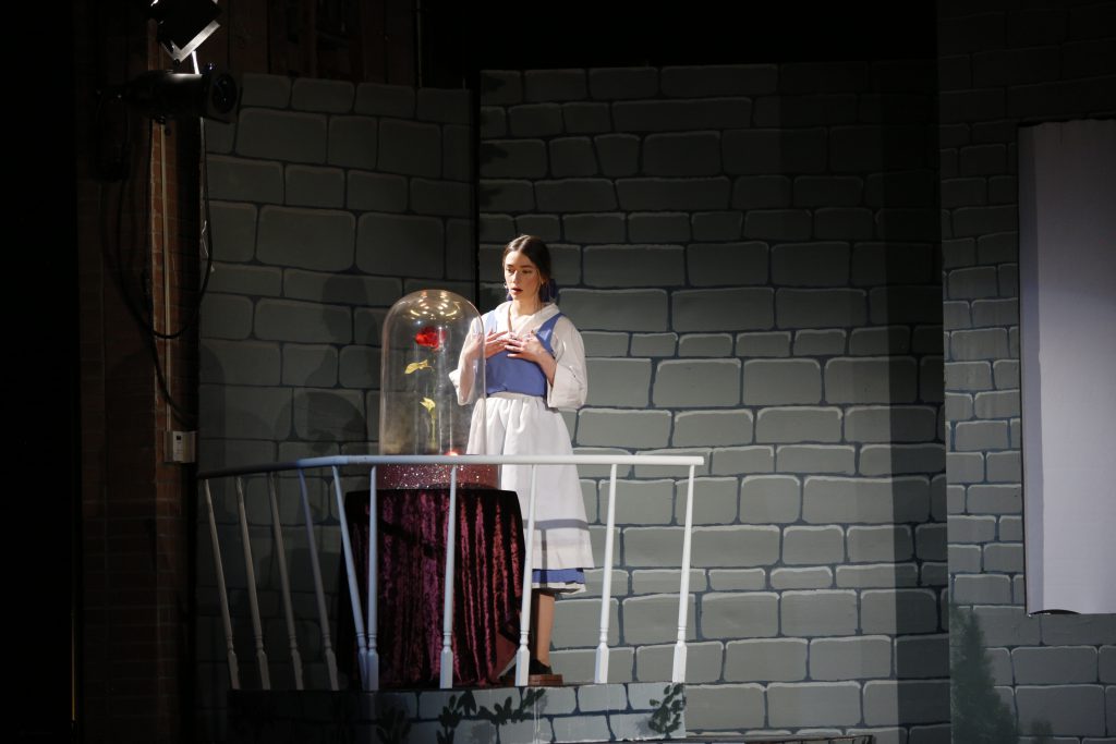 Student sings a song from Beauty and the Beast during rehearsal.