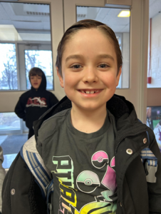 Elementary student smiles at the camera