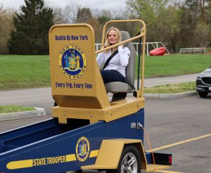 Student participates in seat belt convincer