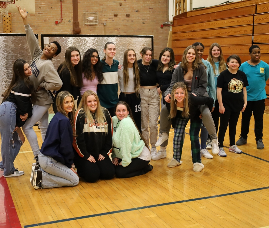 A group of students gather for a picture after a dance activity.