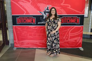 Woman standing in front of the Guilderland photo backdrop.