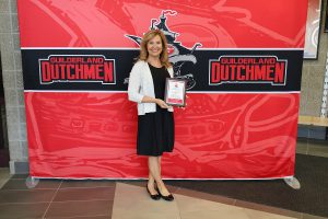 Woman standing in front of the Guilderland photo backdrop.