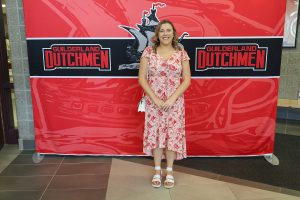 Woman standing in front of the Guilderland photo backdrop.