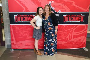 Two women standing in front of the Guilderland photo backdrop.