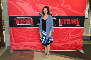 Woman standing in front of the Guilderland photo backdrop.