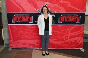 Woman standing in front of the Guilderland photo backdrop.