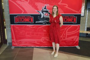 Woman standing in front of the Guilderland photo backdrop.