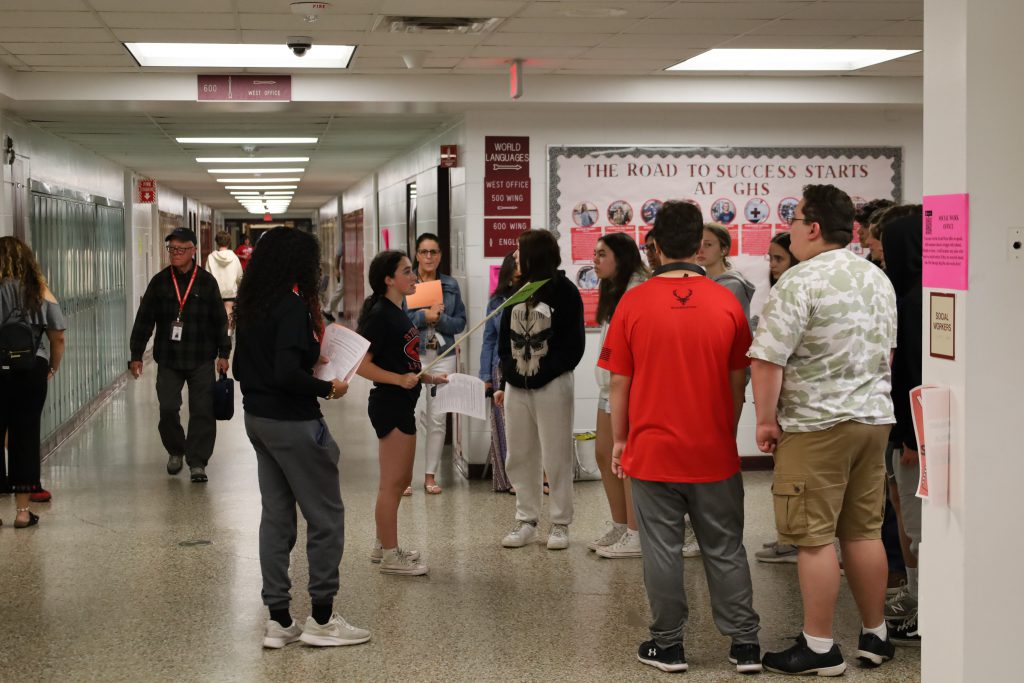 Students stopped in the hallway while taking a tour of the building.