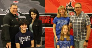 Students pose with their families in front of Guilderland banner as they sign their letters of intent to their selective collectives. 