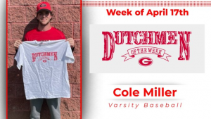 Student holds up a white Dutchmen of the Week t-shirt