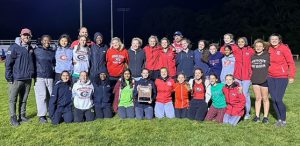 A group of track athletes and coaches pose with Section 2 plaque.