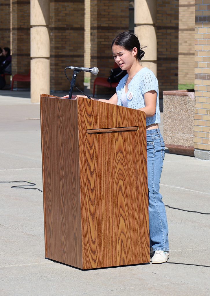 Student speaking at podium.