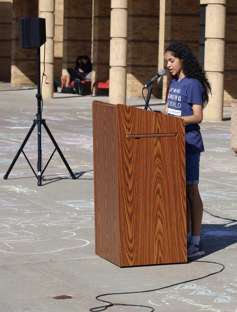 Student speaking at podium.