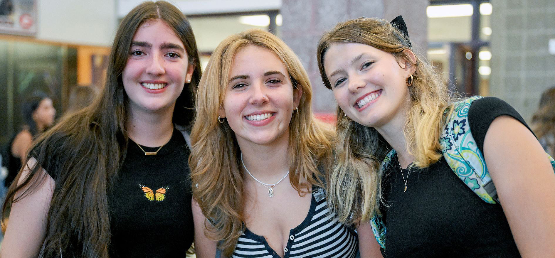 Three students smiling.