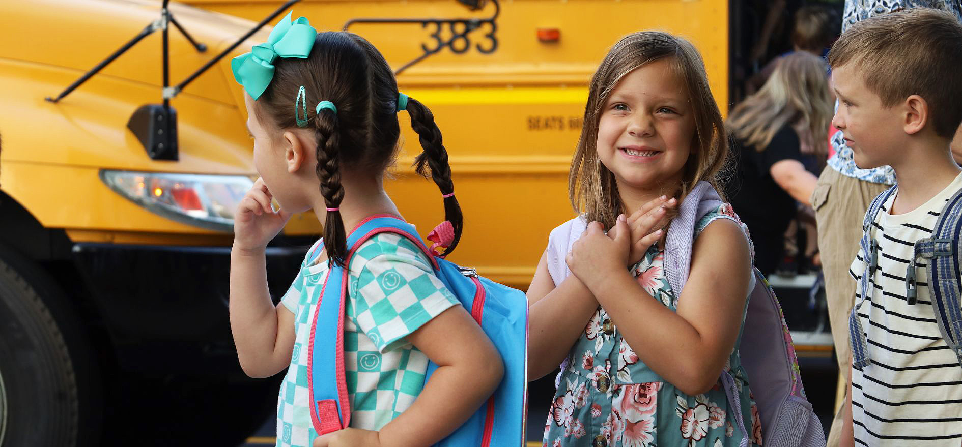 Elementary student smiling with excitement.