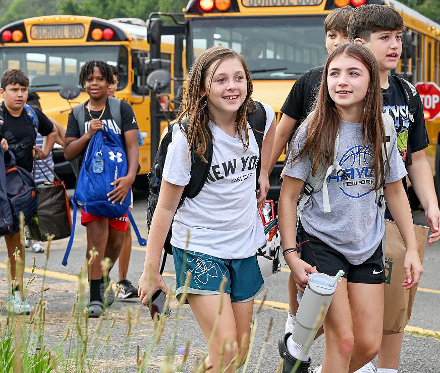 Students smiling as they walk.