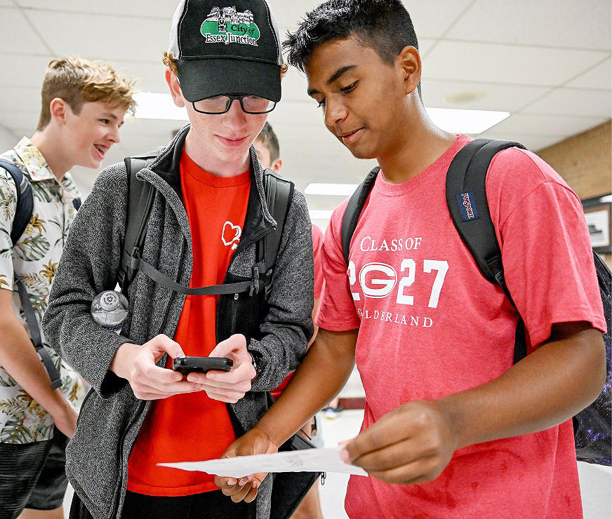 Students looking at a paper.