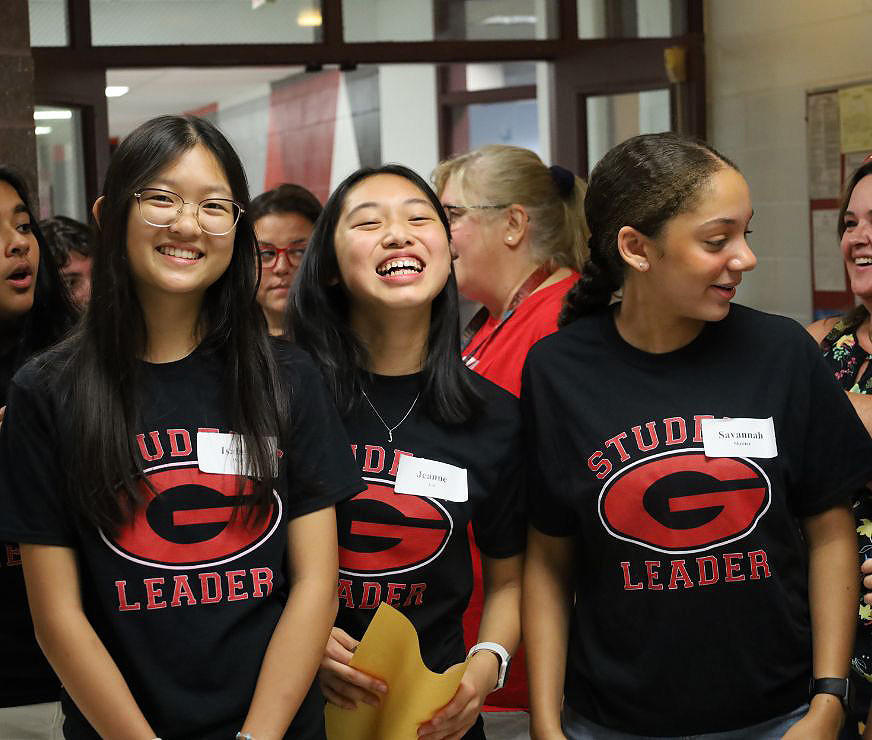 Three student leaders smiling.